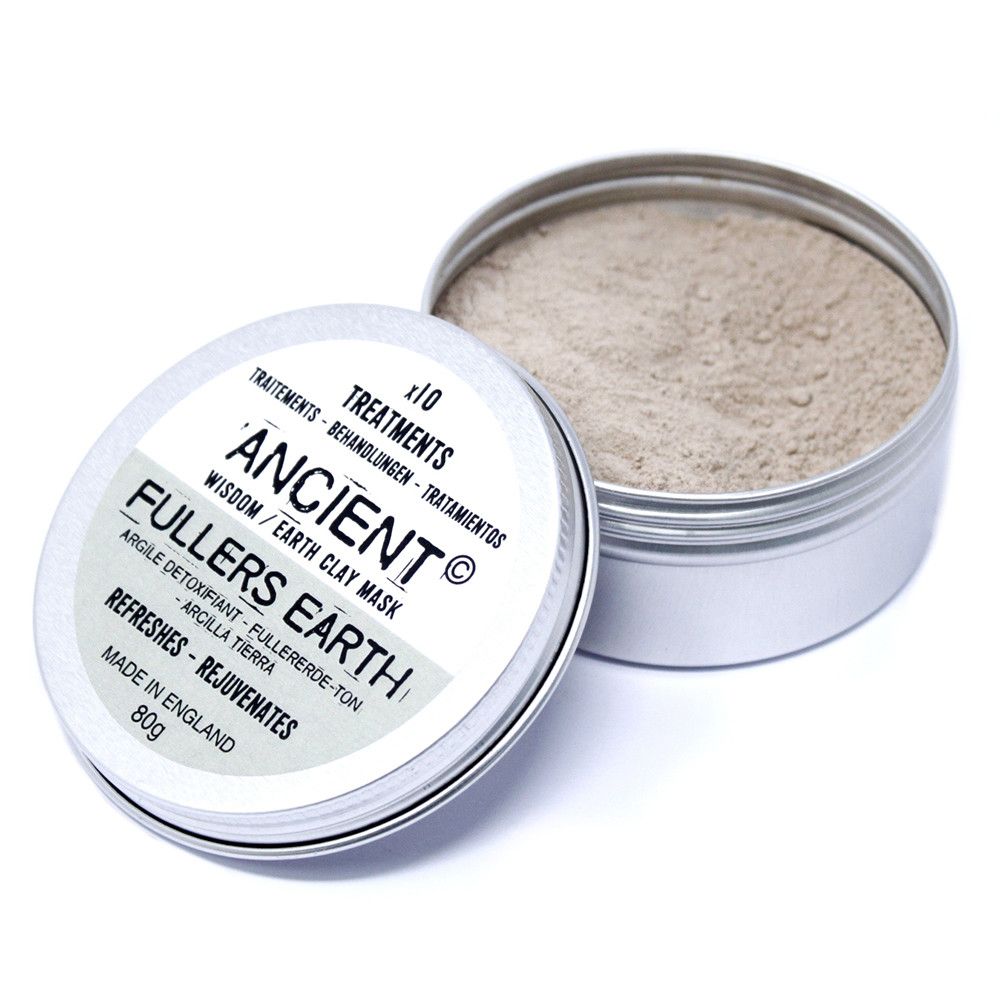 Fine natural clay powder in a clear container for a purifying facial treatment.