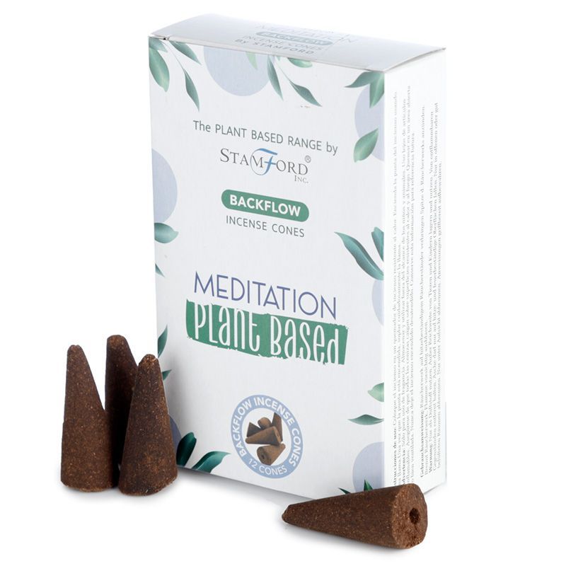 Backflow incense cone shaped for a meditation ritual, releasing a thick plume of smoke that flows downwards like water.