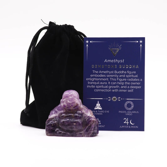 Large hand-carved purple amethyst gemstone Buddha statue in a meditative pose.
