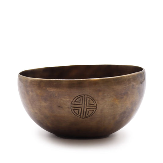 Handcrafted brass singing bowl featuring etched moon phase symbols around the exterior rim.