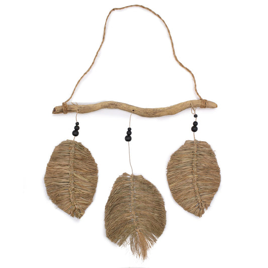 A set of three handcrafted raffia leaves in a natural finish, displayed as decorative wall art.