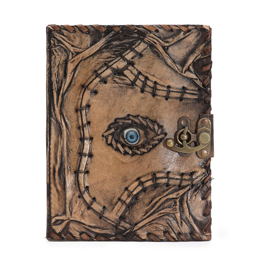 Tan leather notebook with an embossed evil eye design and rustic deckle-edged paper pages.