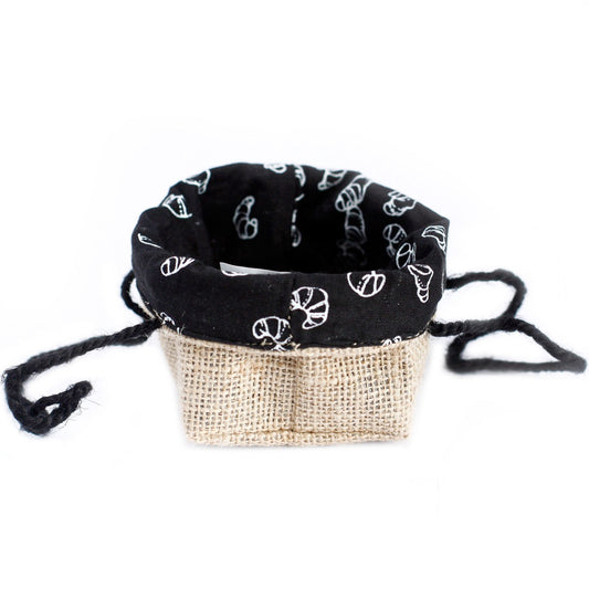 Small natural jute gift bag with a black cotton lining and sturdy woven handles on a plain background.