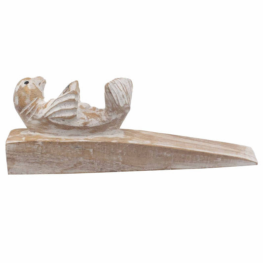 Hand carved wooden doorstop shaped like a cute baby seal with a natural wood finish.