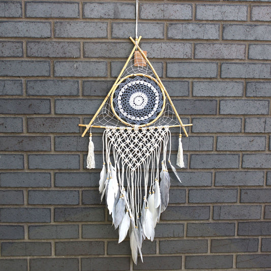 Large white and grey macrame dream catcher in a unique pyramid shape featuring a protective blue evil eye symbol.