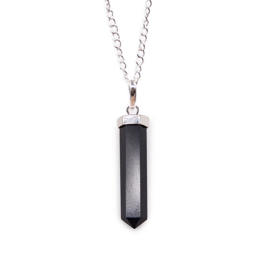 Polished black agate gemstone carved into a classic hexagonal point pendant with a silver-toned bale.