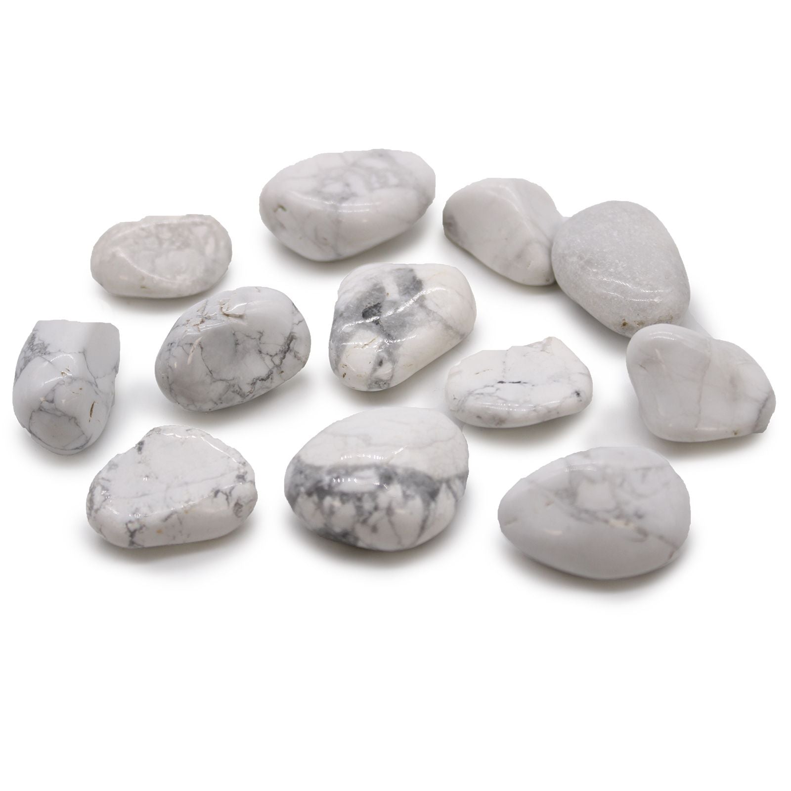Smooth, white tumbled stones with grey marble-like veining, showcasing the natural beauty of Howlite and Magnesite.