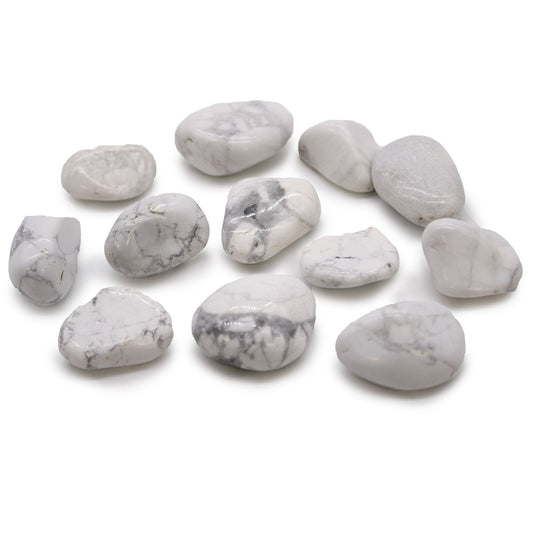 Smooth, white tumbled stones with grey marble-like veining, showcasing the natural beauty of Howlite and Magnesite.