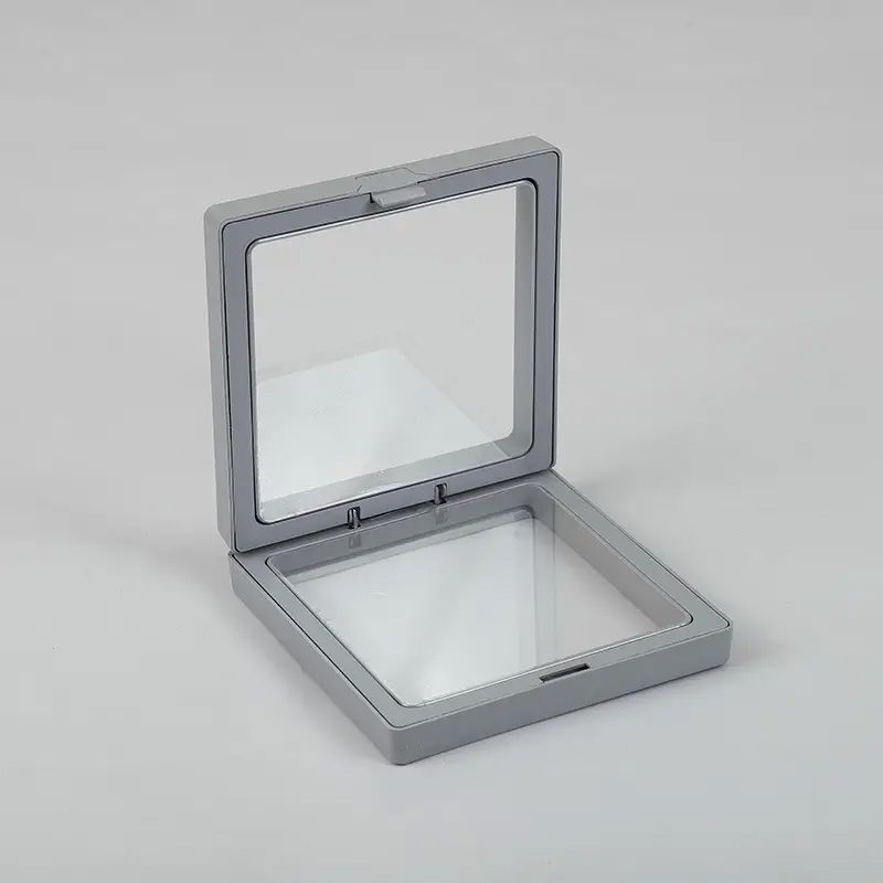Square grey 3D floating frame display with a clear flexible membrane for suspending small objects.