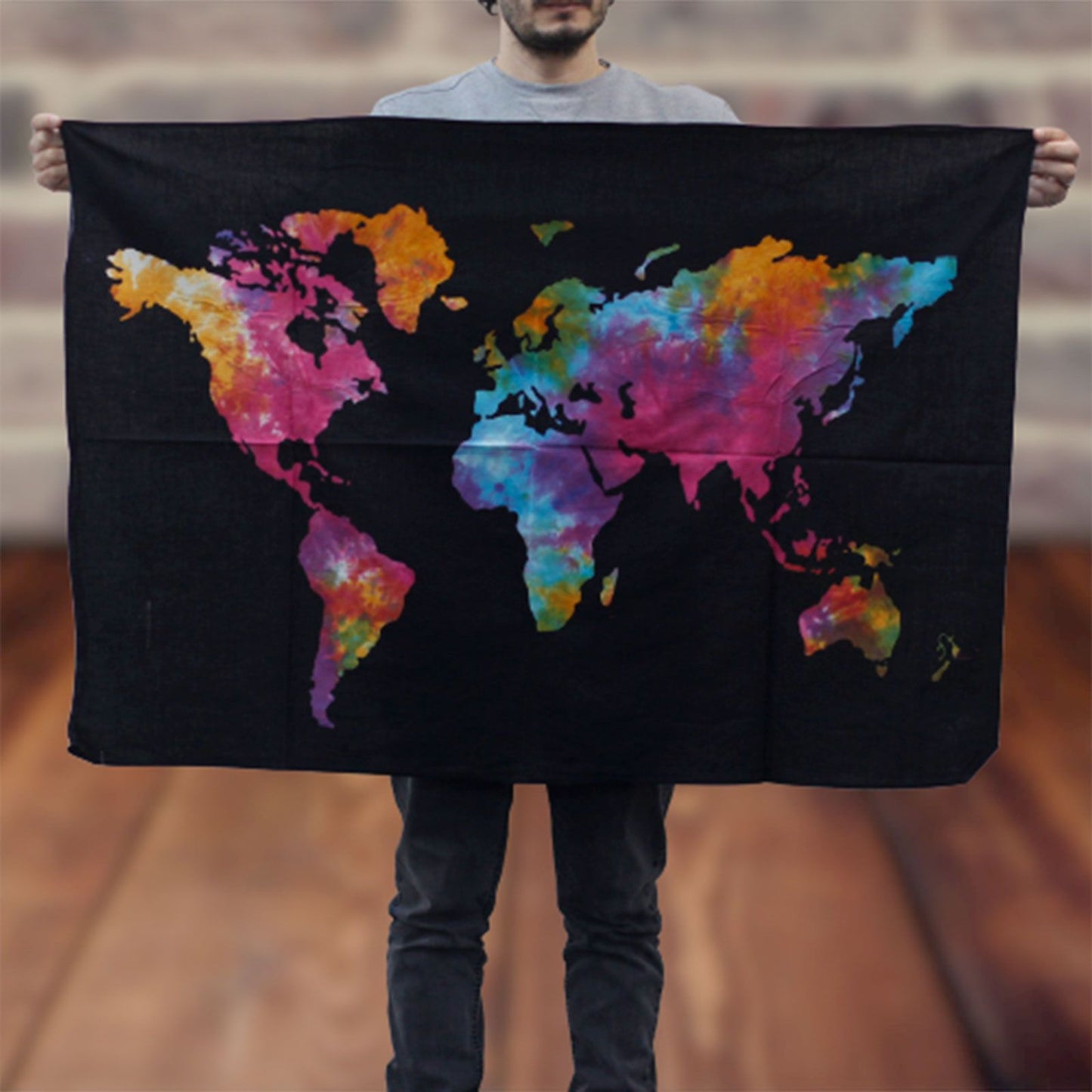 Large cotton wall hanging featuring a colourful world map design against a bold black background.