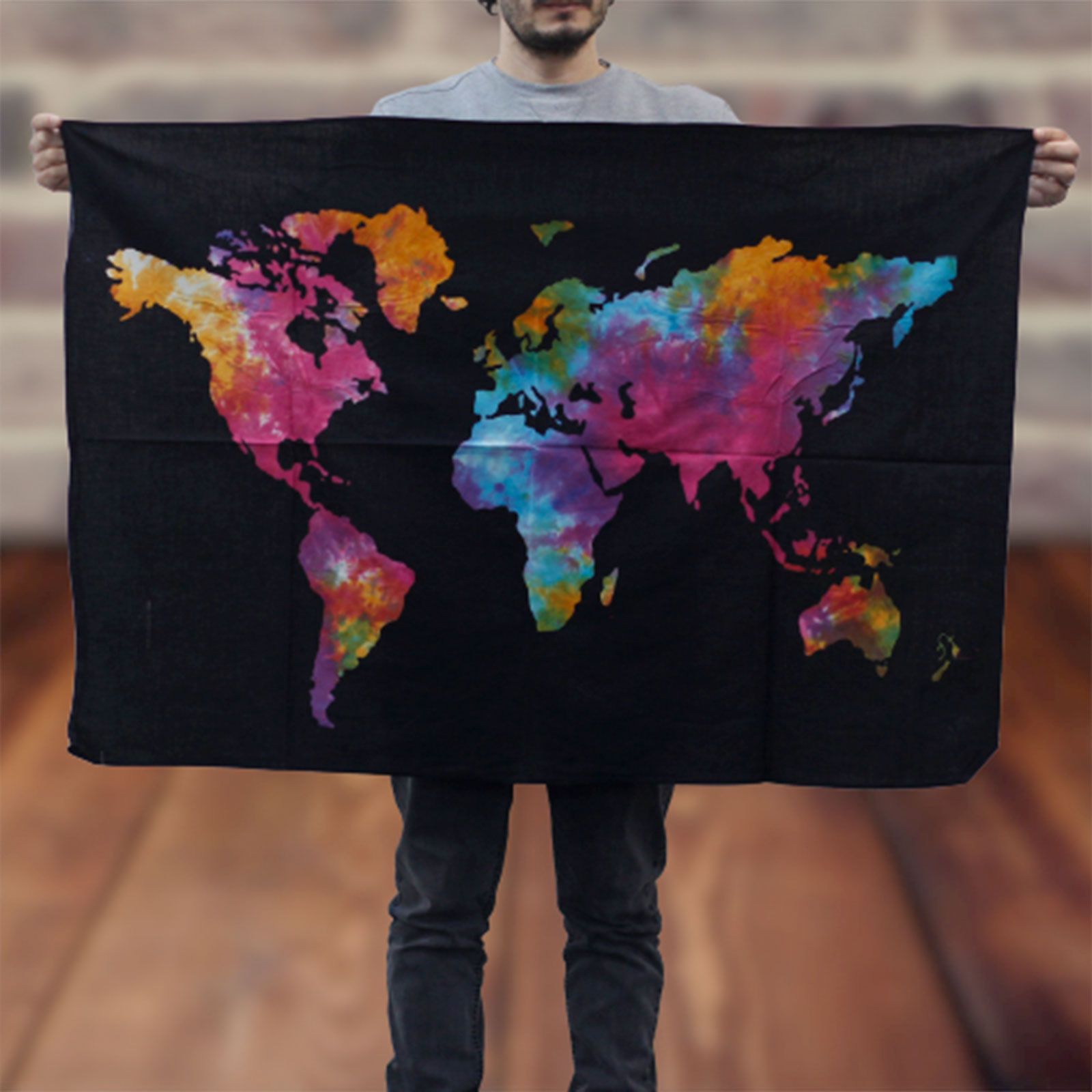 Large cotton wall hanging featuring a colourful world map design against a bold black background.
