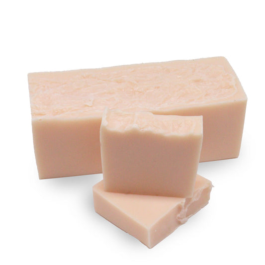 Large rectangular hand-crafted soap loaf with a vibrant peach and white marbled design and textured top.