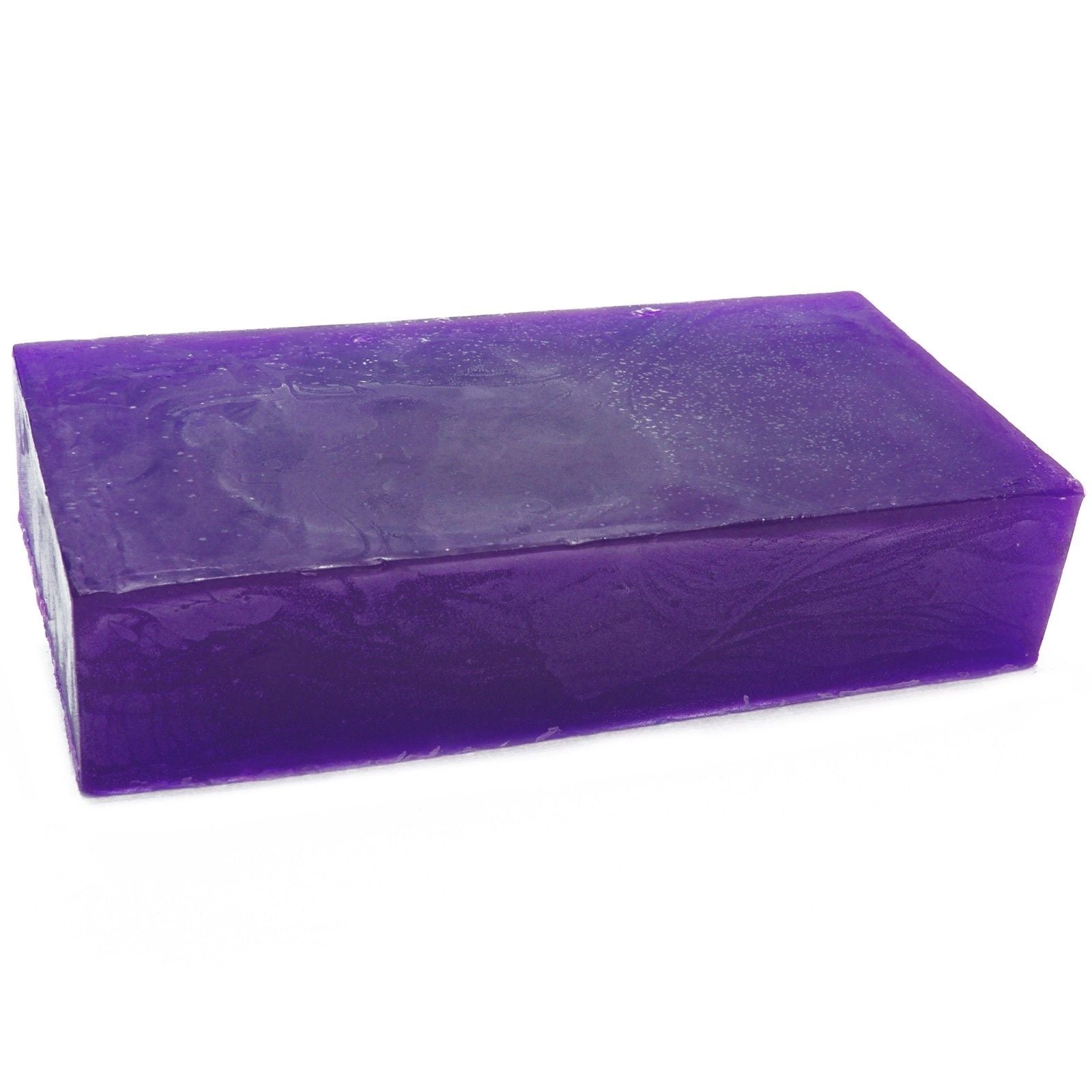 Large artisanal pink soap loaf infused with geranium essential oil, showing a rustic textured surface.