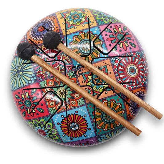 Vibrant multi-coloured steel tongue drum with a circular design and matching mallets for sound healing.
