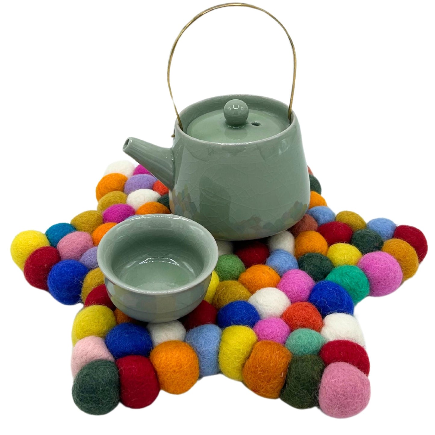 Handcrafted star-shaped centre mat made from vibrant, multi-coloured felt balls arranged in a decorative pattern.