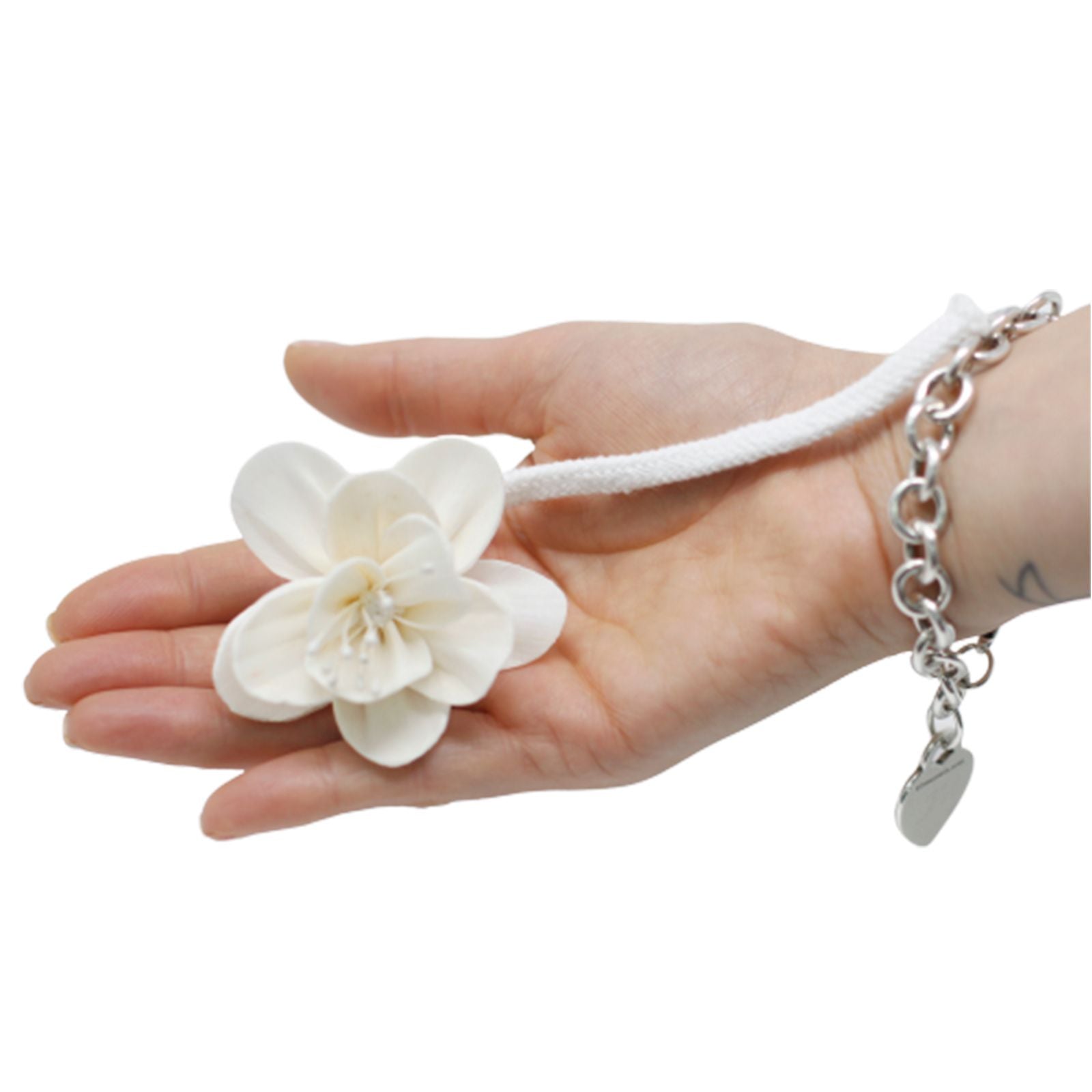 Handcrafted white sola wood lily flower attached to a cotton string for use as a natural aroma diffuser.