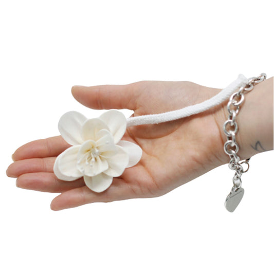 Handcrafted white sola wood lily flower attached to a cotton string for use as a natural aroma diffuser.