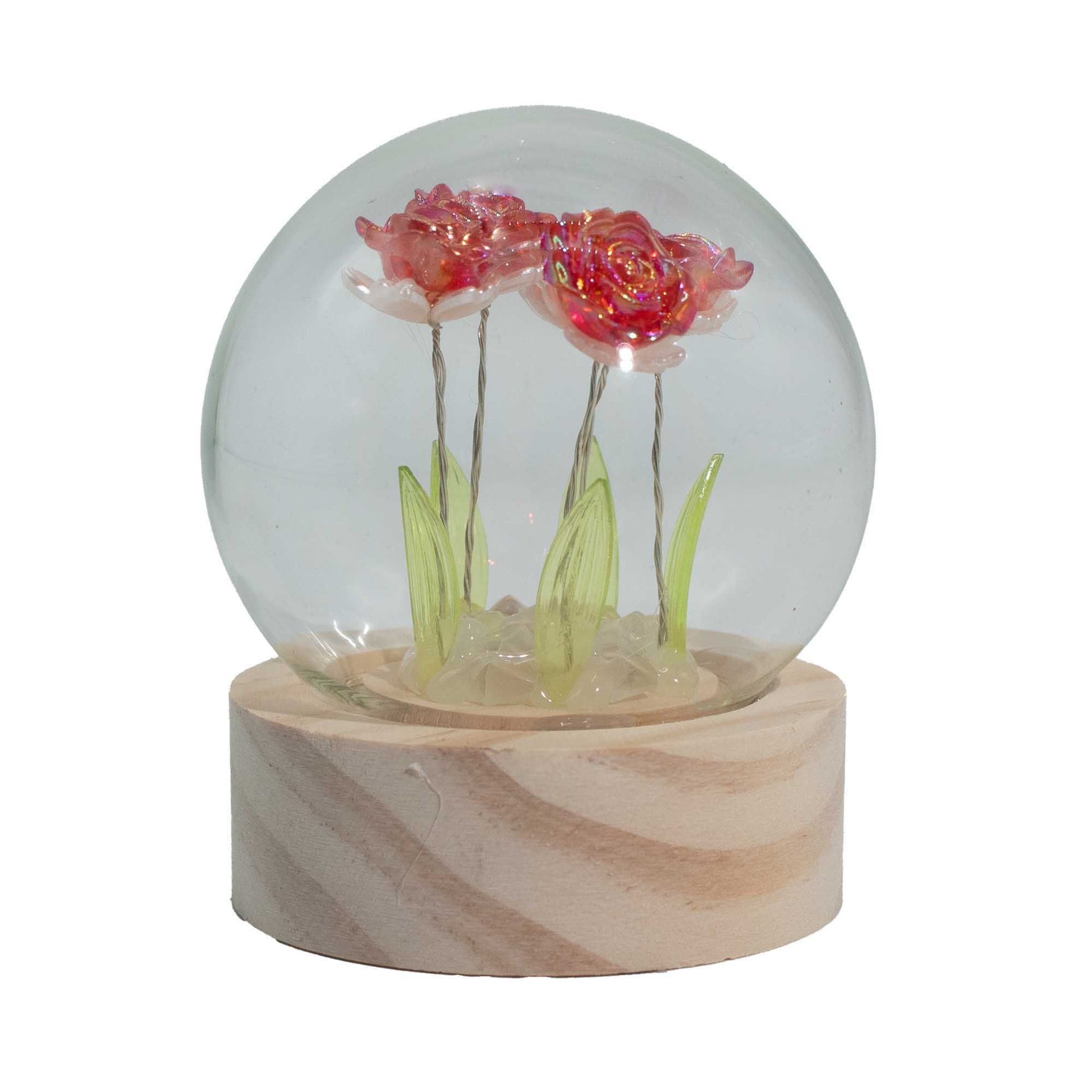 Five realistic artificial red roses illuminated by warm LED lights inside a clear glass display dome on a dark base.