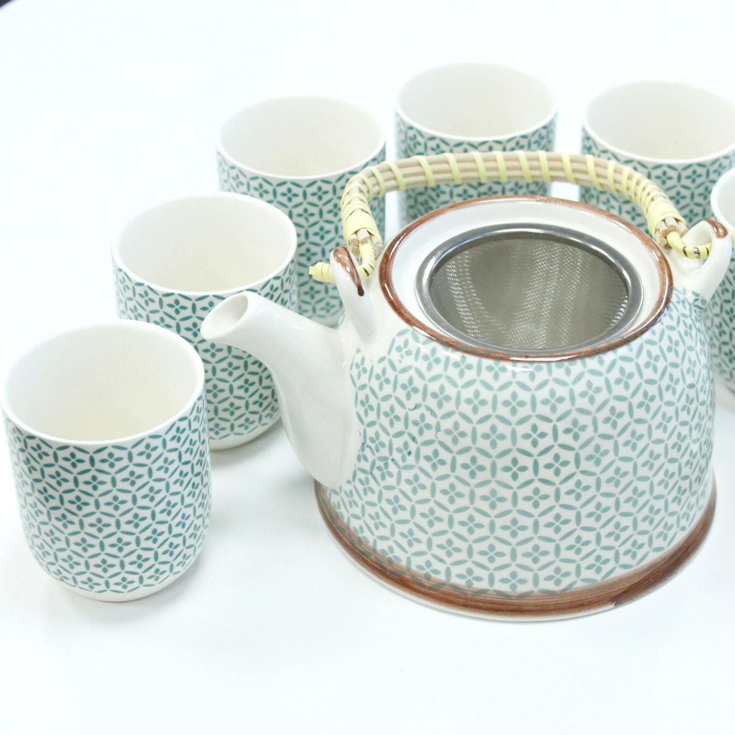 Ceramic herbal teapot and six matching cups featuring a vibrant green mosaic pattern with a built-in metal strainer.