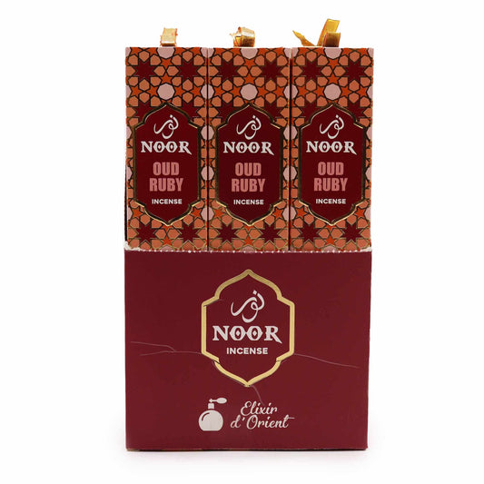 A pack of premium oud incense sticks with rich ruby red packaging on a neutral background.