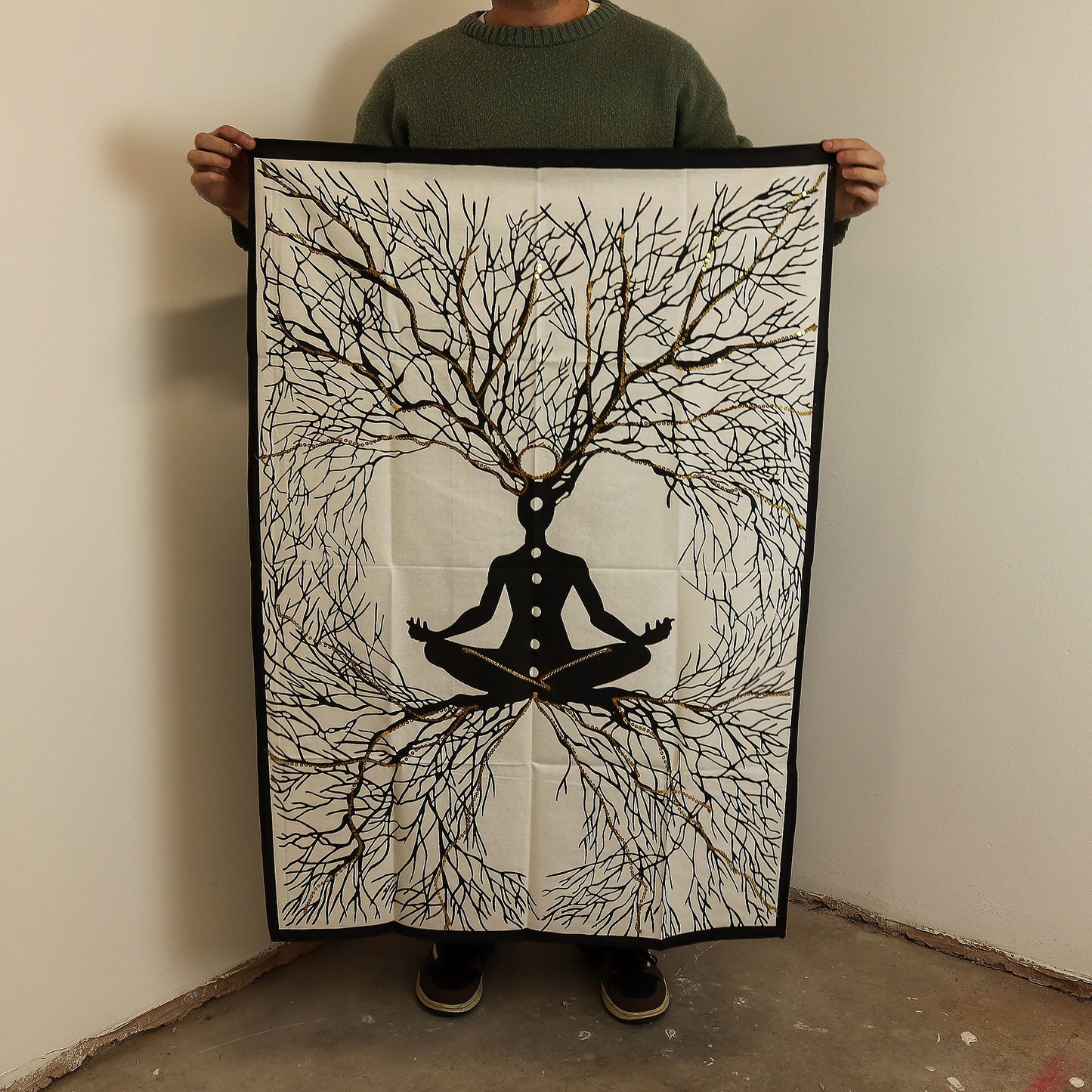 Detailed cotton wall hanging depicting a meditative figure with deep roots and golden highlights on a dark background.