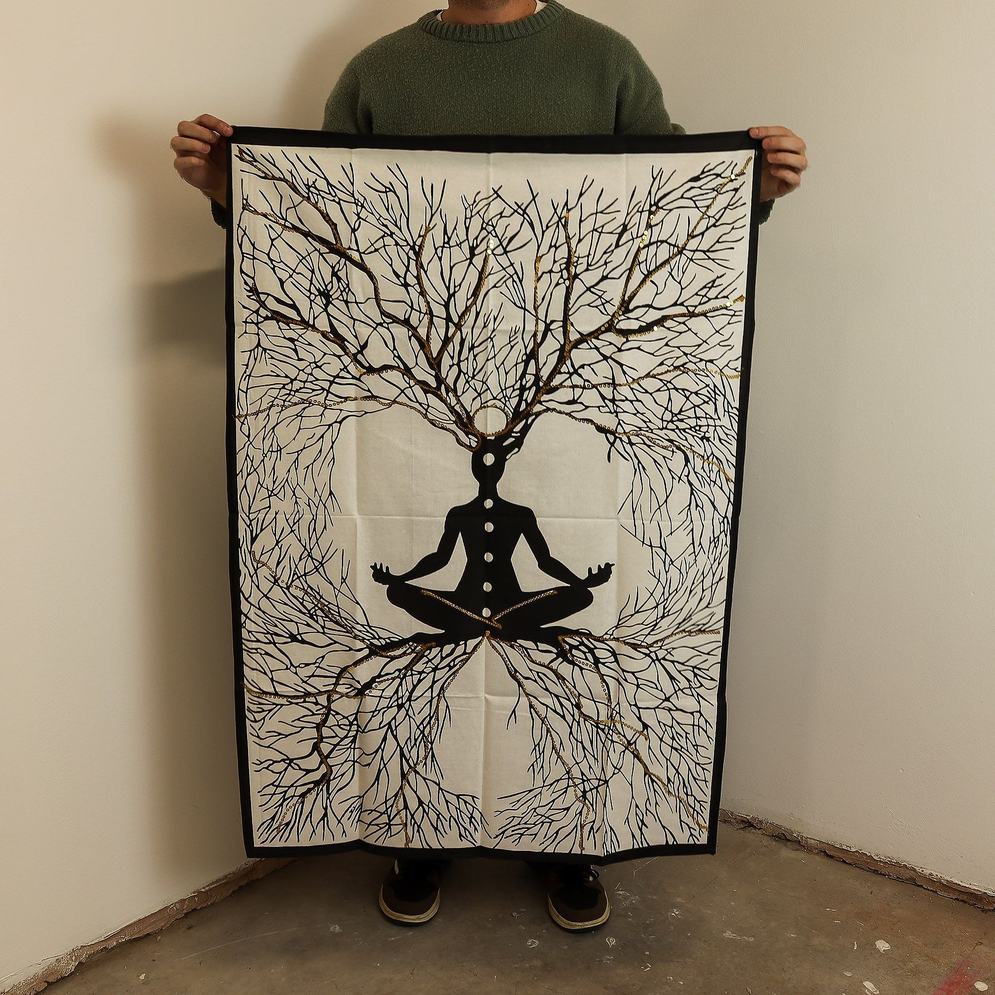 Detailed cotton wall hanging depicting a meditative figure with deep roots and golden highlights on a dark background.