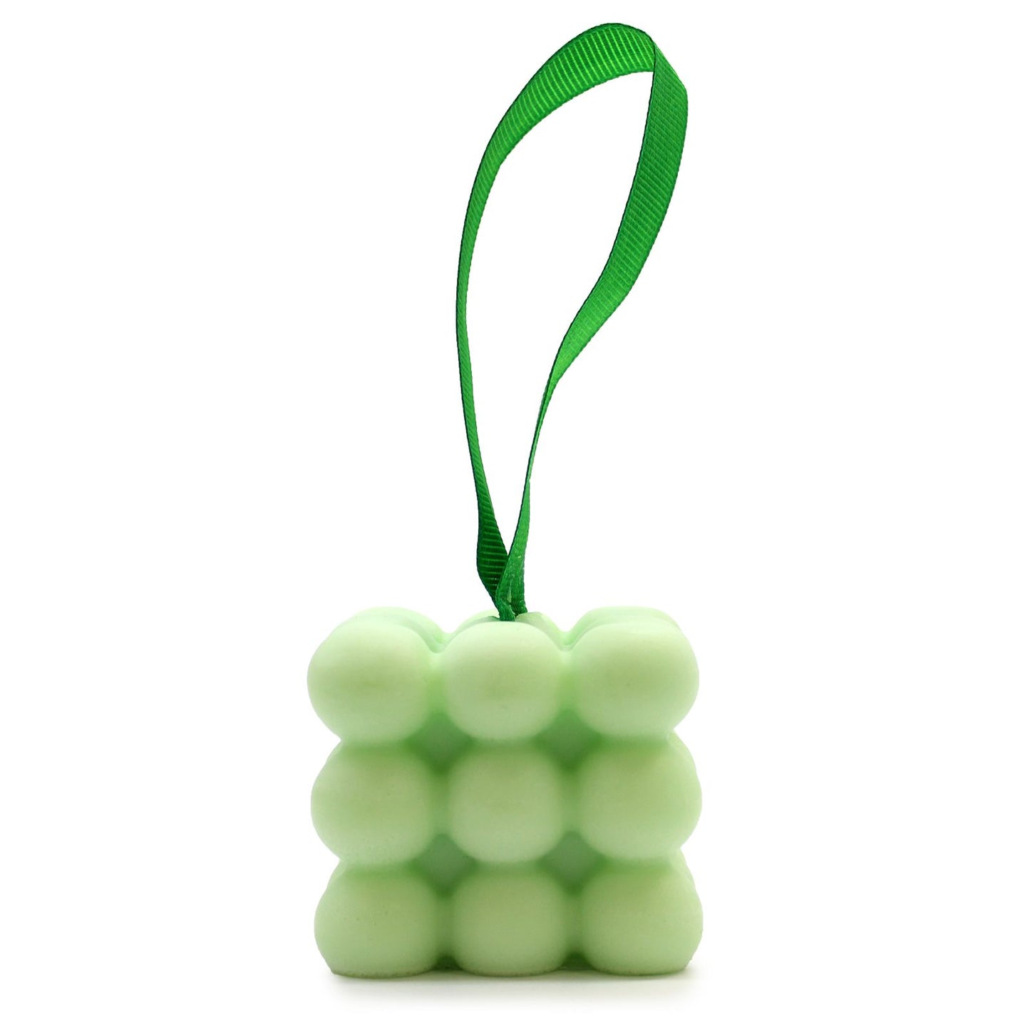 Nubbly textured green massage soap bar tied with a decorative ribbon in a gift box.