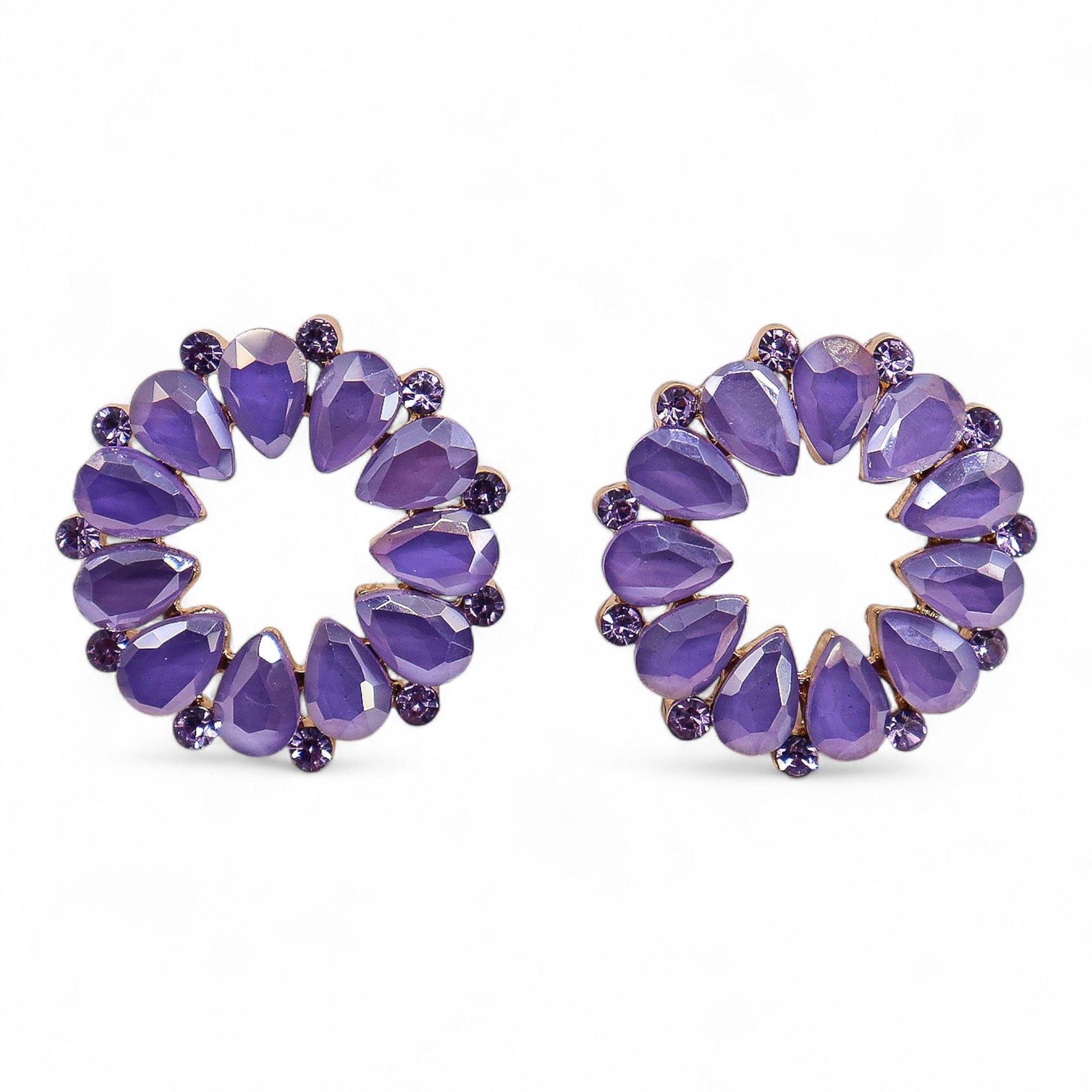 Elegant circular loop earrings made of stainless steel and smooth glass with shimmering lilac and lavender tones.