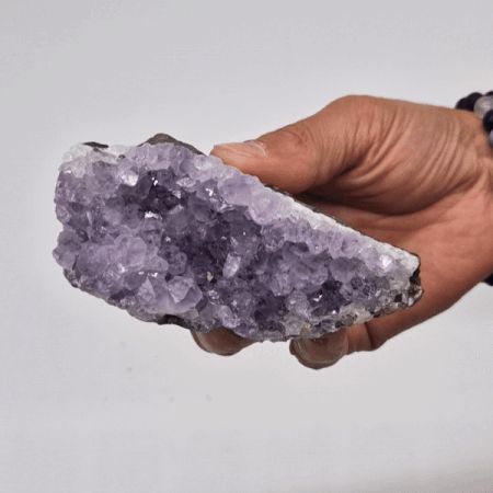 High-grade deep purple amethyst crystal standing cluster with a natural rocky base and vibrant shimmering points.