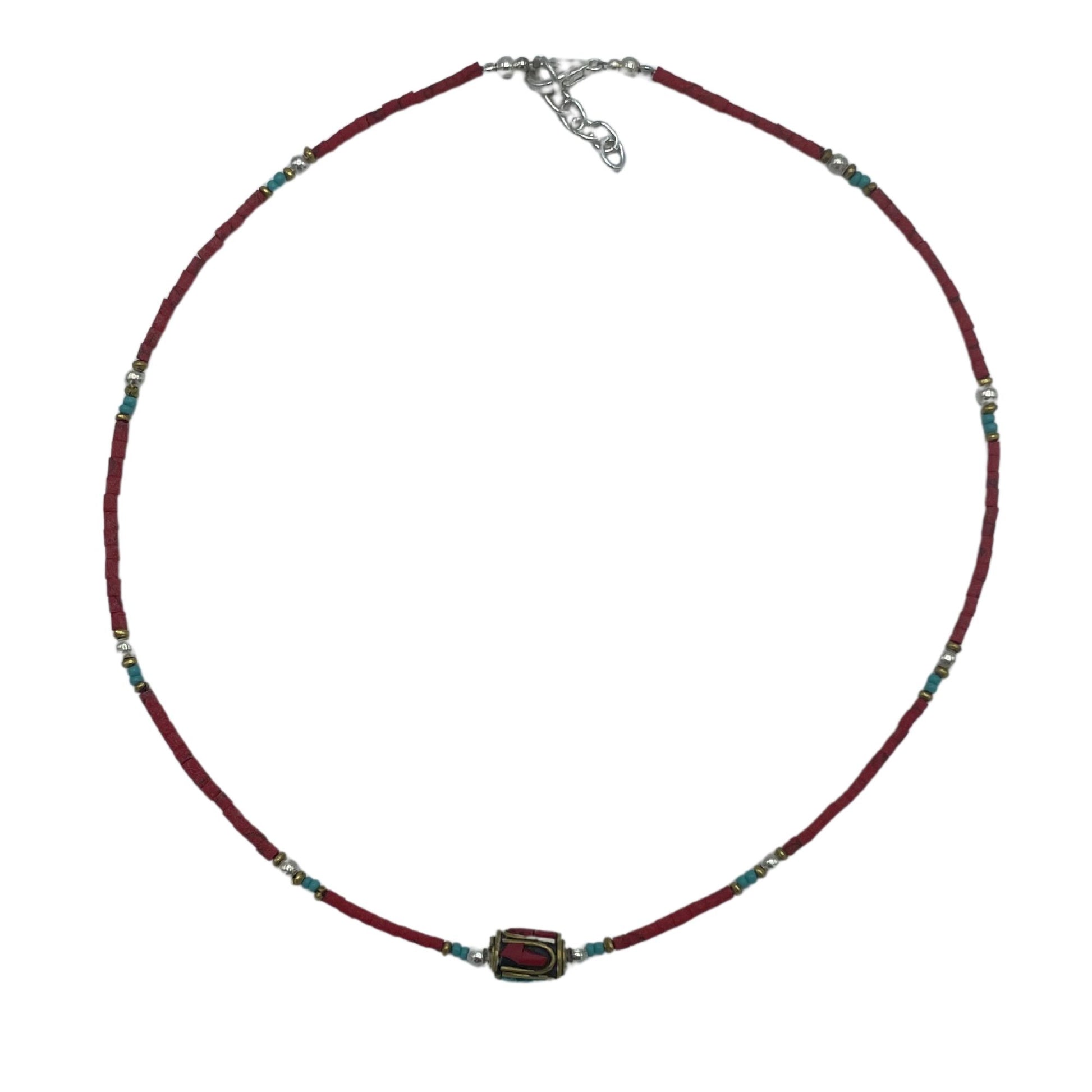Handcrafted Nepalese necklace featuring vibrant red coral beads and intricate silver-tone tribal style accents.