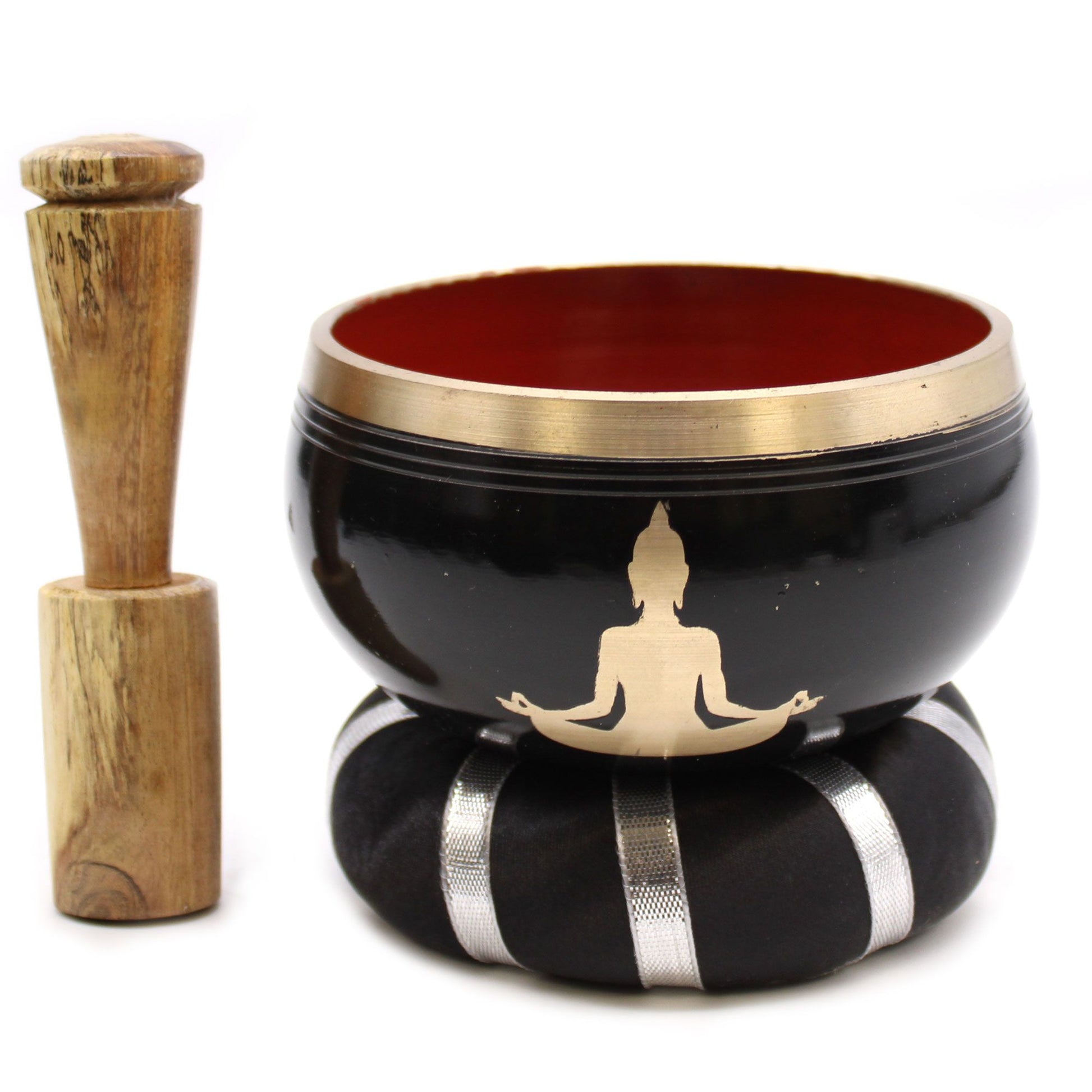 Handcrafted black and orange Tibetan singing bowl set with intricate Buddha design and wooden mallet on a plain background.