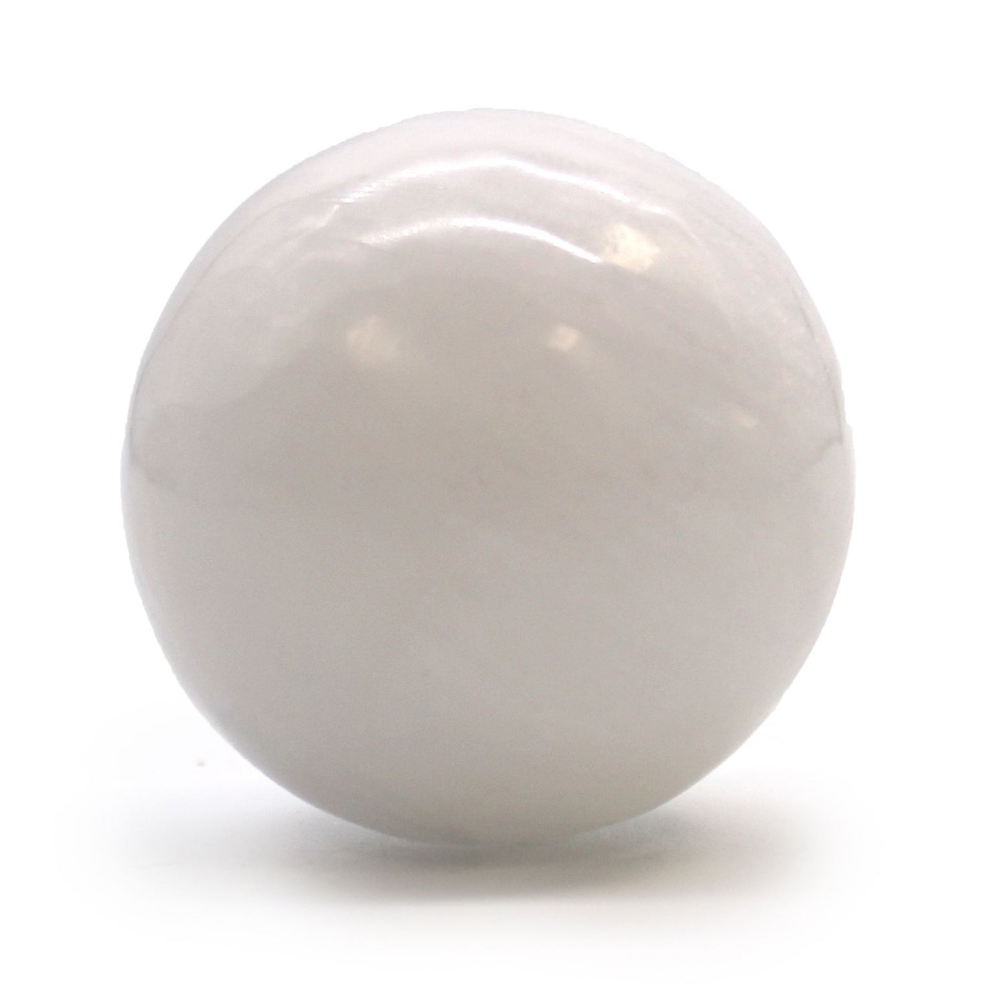 Smooth white Moroccan selenite crystal sphere showing natural milky translucency and light-refracting properties.