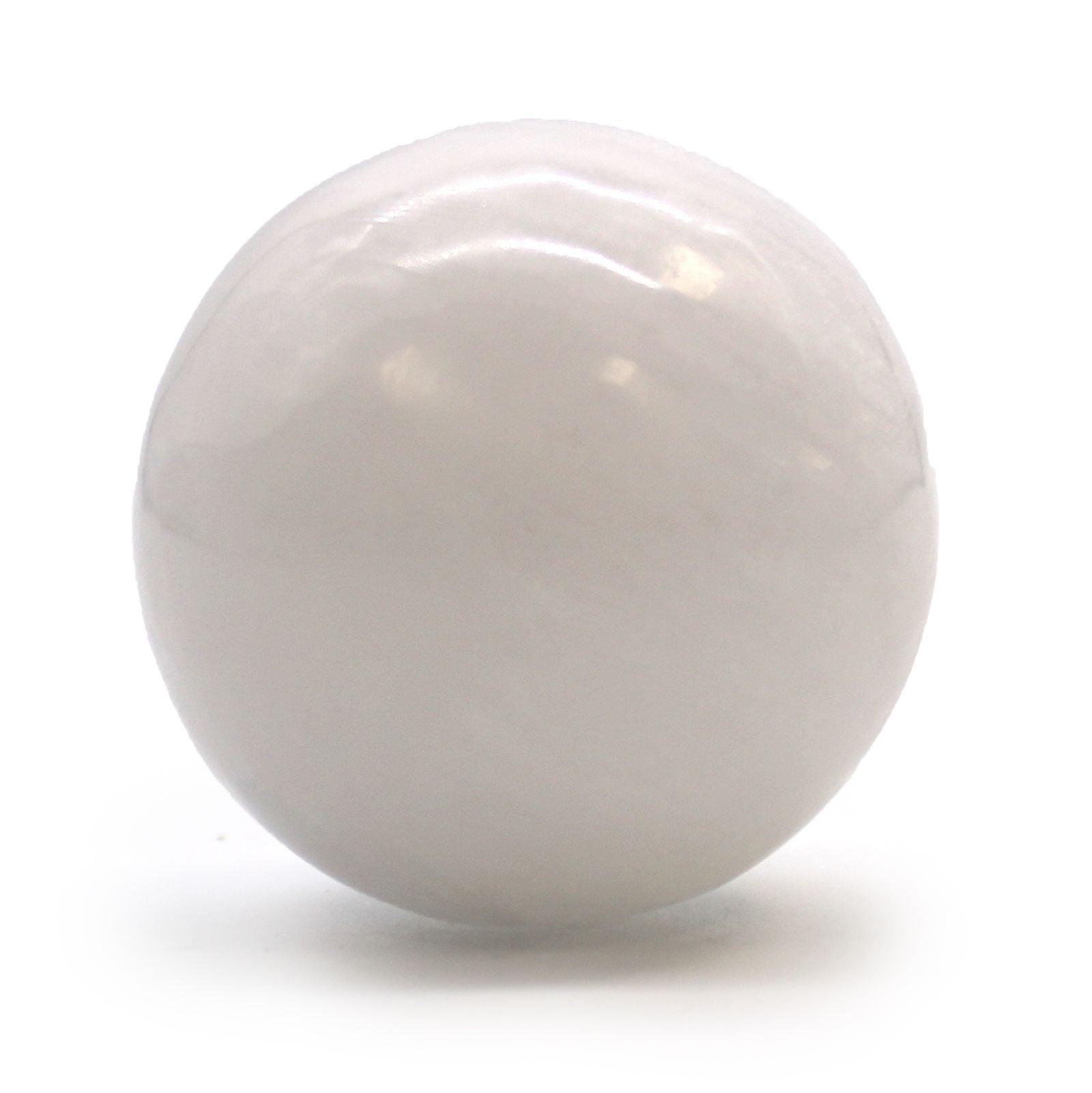 Smooth white Moroccan selenite crystal sphere showing natural milky translucency and light-refracting properties.