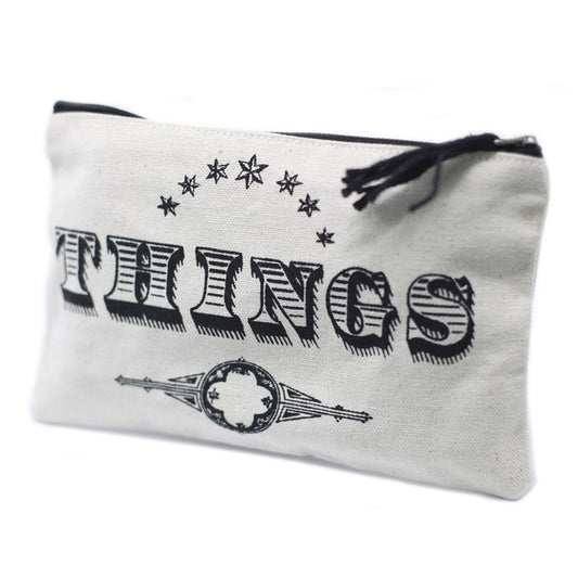 Soft cream-coloured fabric zip pouch with 'Things' printed on the front, featuring a simple black zipper closure.