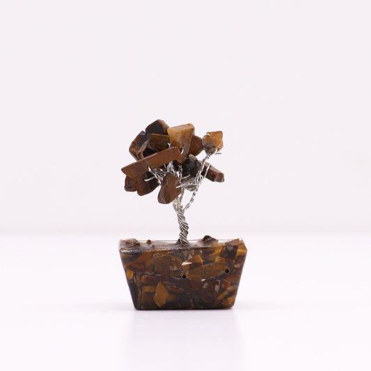 Handcrafted mini gemstone tree with gold-tone wire and tiger eye crystal leaves on a round orgonite pyramid base.
