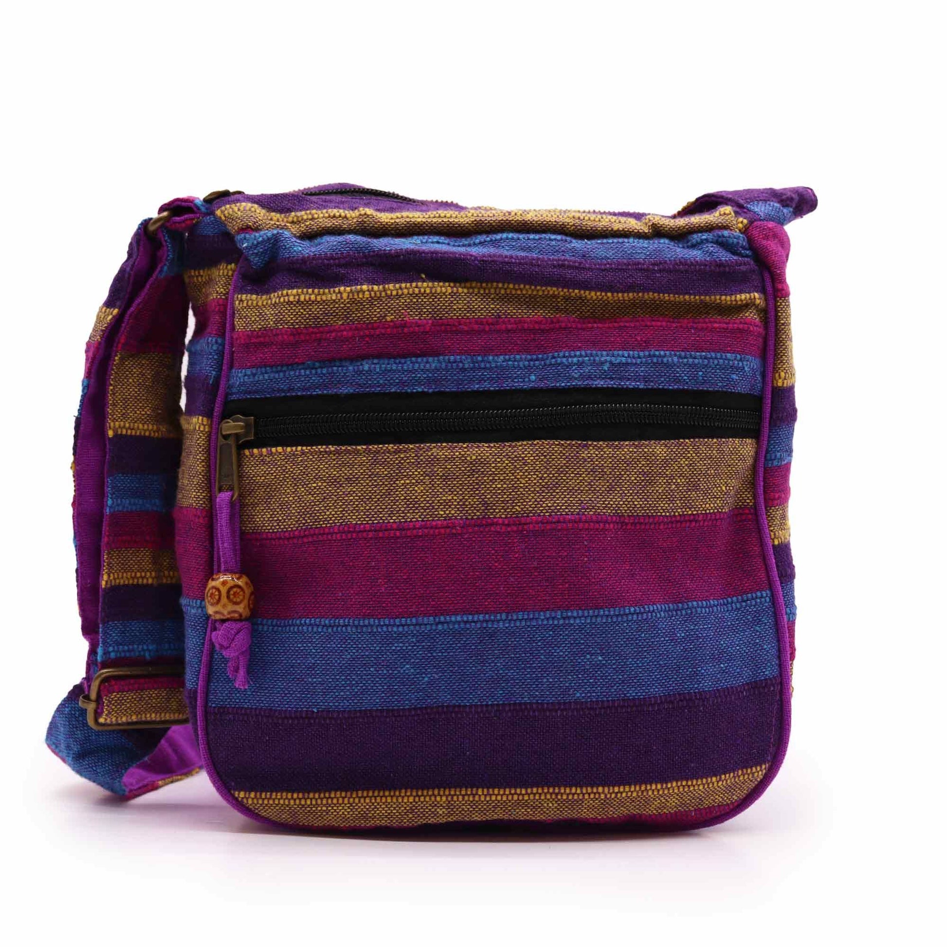 Large colourful fabric sling bag with a vibrant wild flower pattern and a long adjustable black shoulder strap.