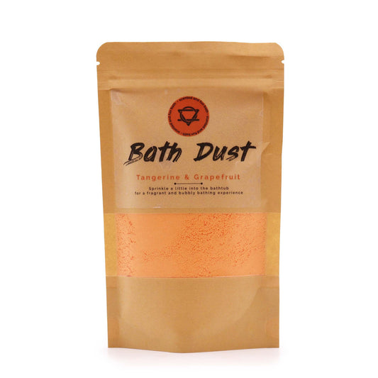 Fine orange and white bath dust in a clear bag, showing a textured citrus-infused powder for aromatherapy baths.