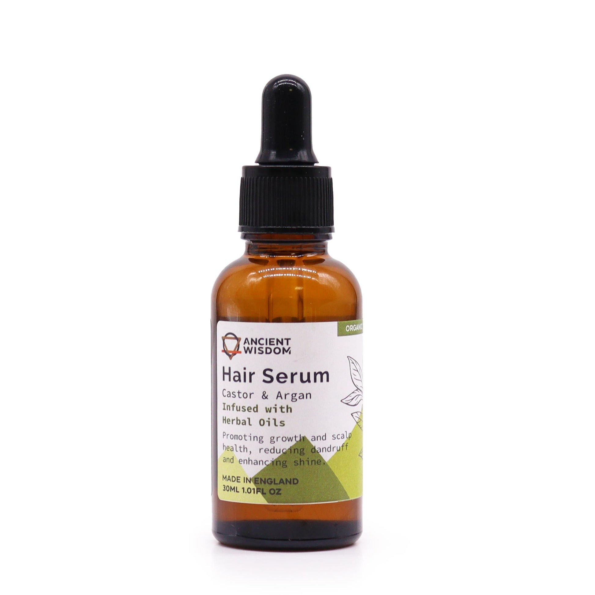 Small amber glass bottle of organic herbal hair serum with a pipette dropper on a neutral background.