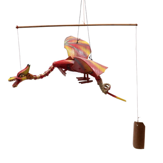 Handcrafted red dragon hanging mobile made from coconut shell with a wide wingspan and detailed carving.