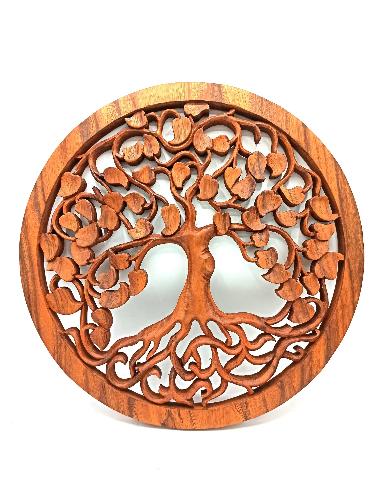 Circular wooden wall carving of the Tree of Life featuring intricate branches and heart-shaped detailing.
