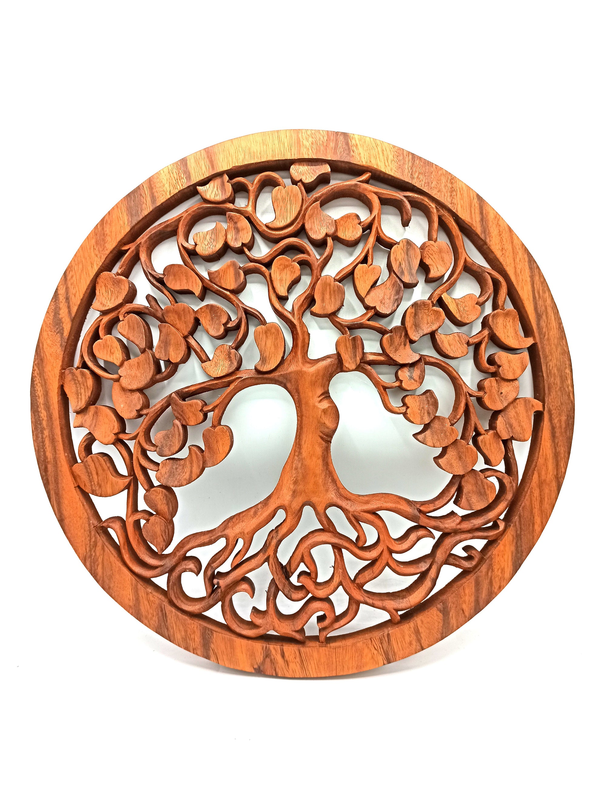 Circular wooden wall carving of the Tree of Life featuring intricate branches and heart-shaped detailing.