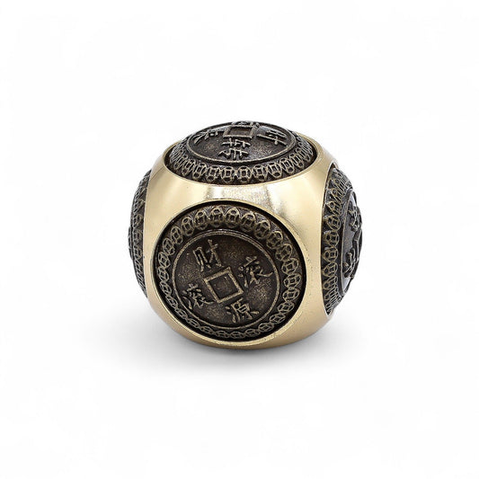 Small rounded decorative dice with intricate traditional Chinese coin motifs symbolising wealth and abundance.