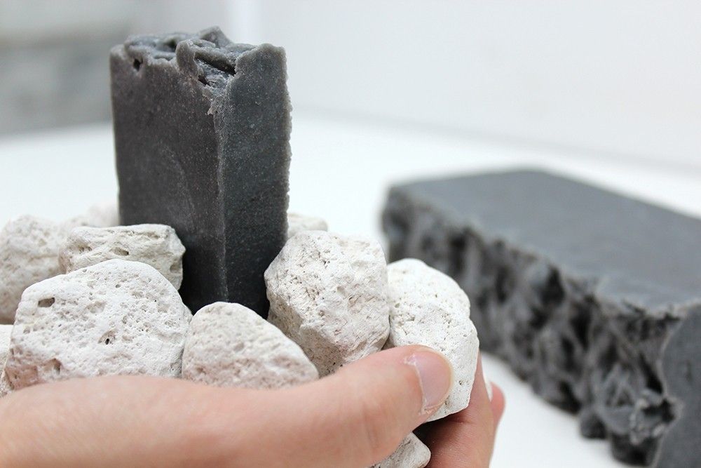 Large rectangular artisan olive oil soap loaf with visible exfoliating pumice particles and a textured surface.