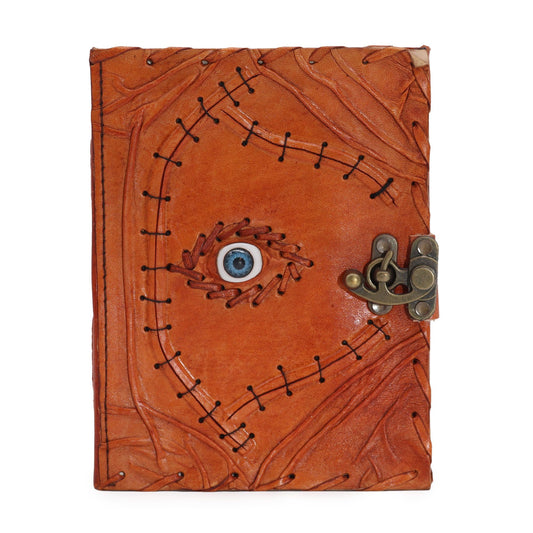 Vintage style tan leather notebook featuring a central evil eye design and textured deckle edge paper pages.