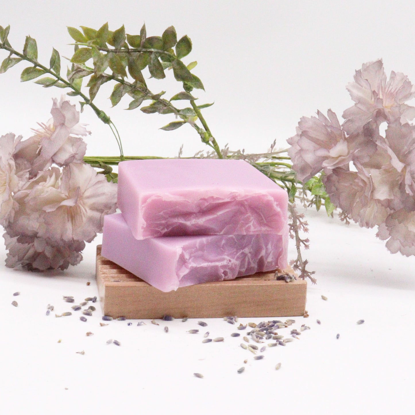Handcrafted purple and white marbled soap bar with dried lavender botanicals on top.