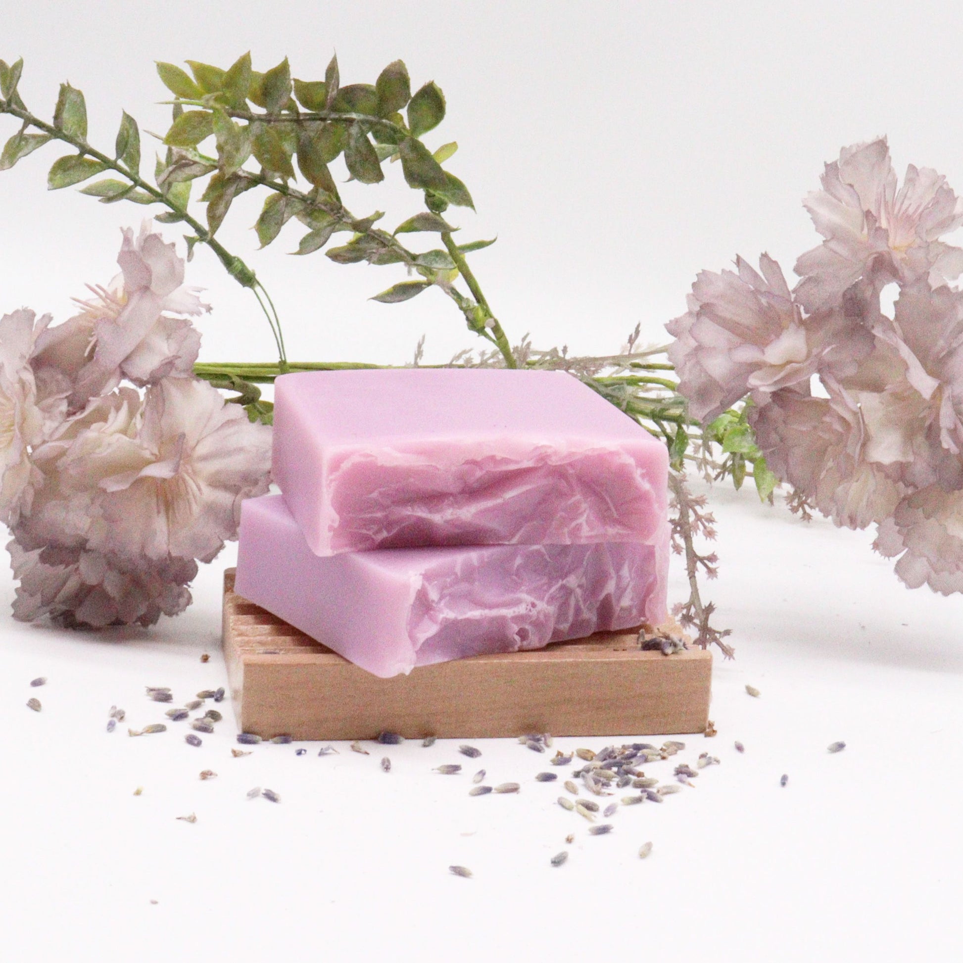 Handcrafted purple and white marbled soap bar with dried lavender botanicals on top.