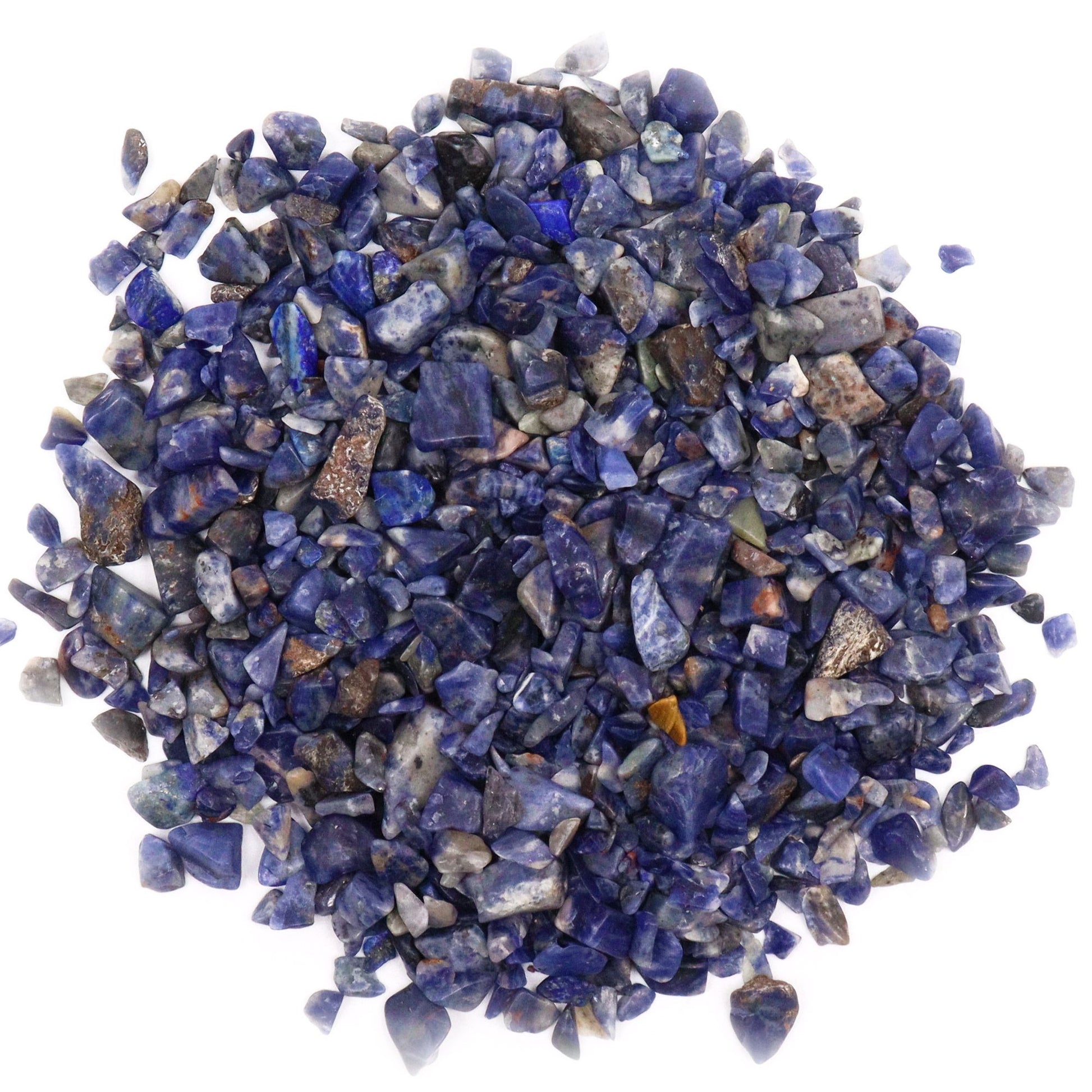 A large collection of small, polished deep blue sodalite gemstone chips with natural white veining.