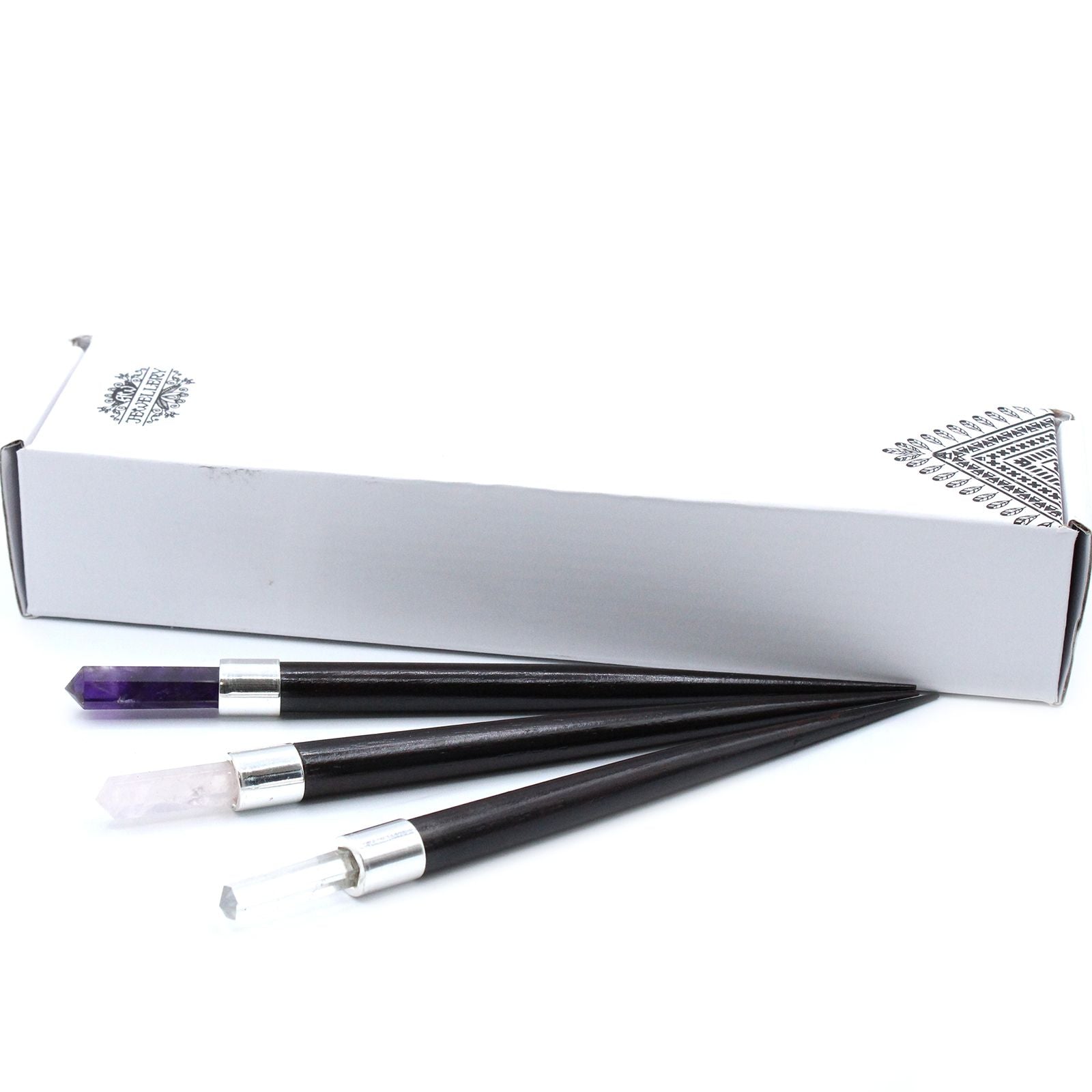 A simple pointed healing wand featuring a trio of rose quartz, rock crystal, and amethyst stones.