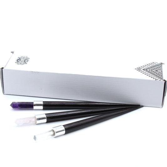 A simple pointed healing wand featuring a trio of rose quartz, rock crystal, and amethyst stones.