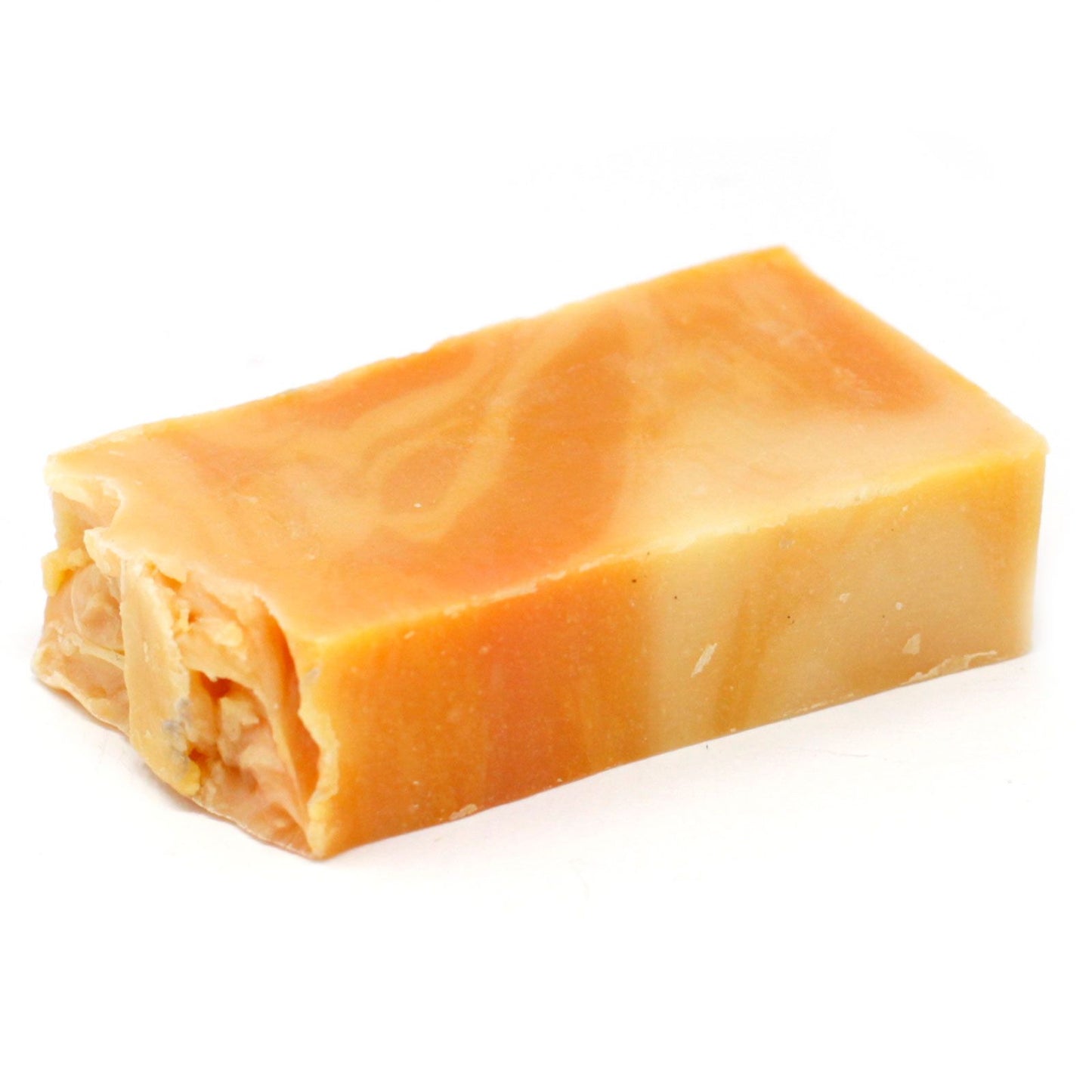 Handmade orange-coloured olive oil soap slice showing a natural rustic texture and traditional cold process finish.